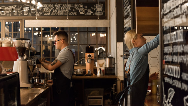 Coworkers of coffee shop making coffee