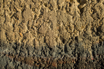 The texture of the cement wall. The concrete wall is stained with paint. Detail of graffiti.