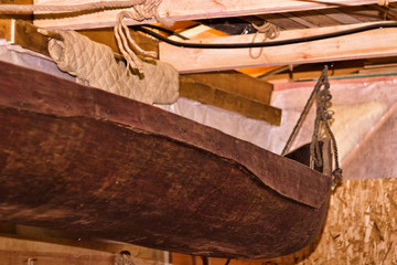 Wooden boat is suspended from the ceiling in the Studio