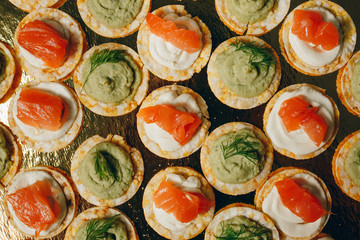 Catering table set service various snacks on a table at banquet. Set of cold snacks, canape, beverages, closeup. Side view. Banquet table
