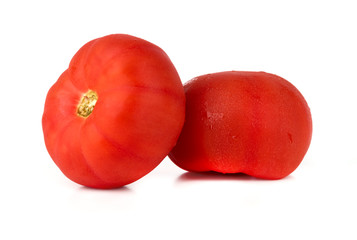 Tomatoes on a white background. Two fresh tomatoes close up.