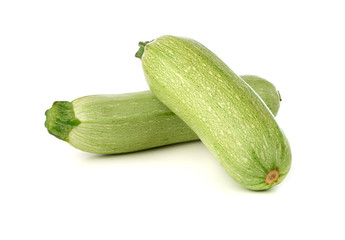 Courgettes on a white background. Green fresh zucchini close up.