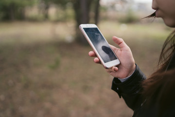 Close up of woman use of mobile phone at outdoor. 