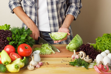 Woman cooks at the kitchen, body part, blurred background