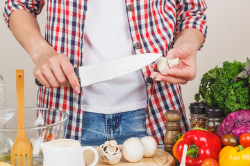 Woman cooks at the kitchen, body part, blurred background
