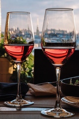 View of historical part of the city of St. Petersburg from the top through the glasses of wine.
