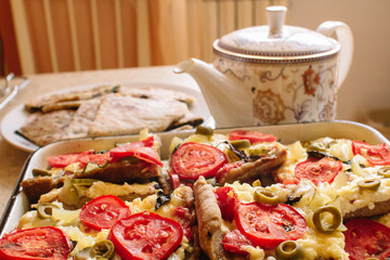 Vegetarian treats pizza with tomatoes, mozzarella and olives and naan with cheese and greens