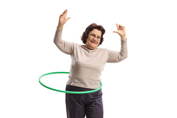 Cheerful elderly woman with a hula-hoop