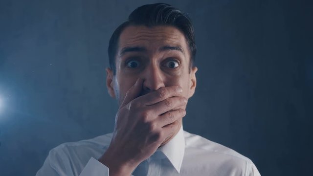 Scared businessman is frightened and afraid covers his face with hand