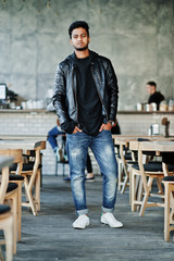 Fototapeta na wymiar Portrait of stylish and casual young asian man wear on leather jacket spending time at cafe.