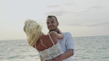 Happy loving couple hugging and twirling around - slow motion