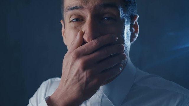 Scared businessman is frightened and afraid covers his face with hand