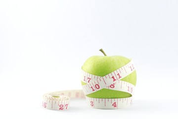 apple with measuring tape isolated on white