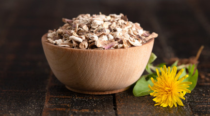 Bowl of Dehydrated Dandelion Root on a Rustic Wooden Table
