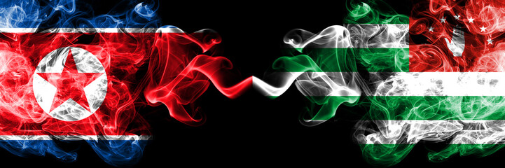 North Korea vs Abkhazia, Abkhazian smoky mystic flags placed side by side. Thick colored silky smoke flags of North Korea and Abkhazia, Abkhazian.