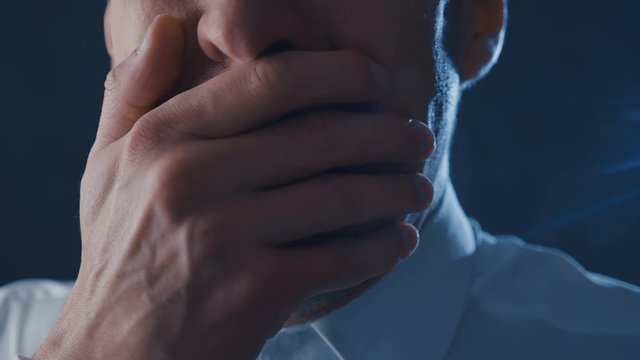 Close-up of a frightened businessman screaming with fear. Horror scene