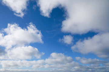 blue sky with white clouds to horizon