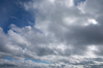 blue sky with white and grey clouds to horizon