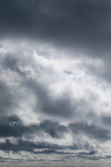 Obraz premium Dramatic sky with grey and white clouds portrait orientation