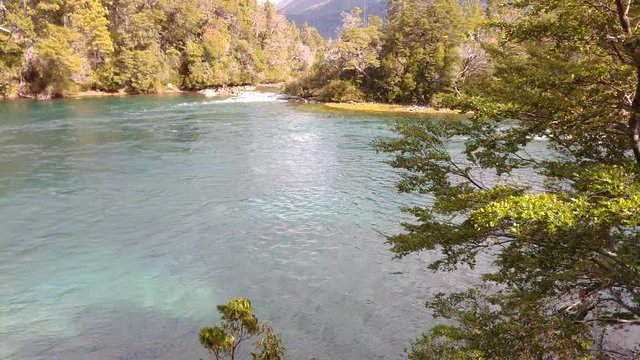 Scene view of Menendez river flowing down with a soft wind on the trees