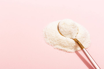 Collagen powder on pink background. Extra protein intake. Natural beauty and health supplement for...