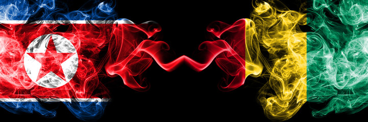 North Korea vs Guinea, Guinean smoky mystic flags placed side by side. Thick colored silky smoke flags of North Korea and Guinea, Guinean.