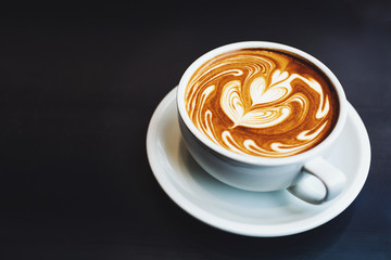 A cup of cappuccino with latte art.