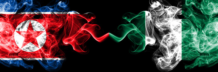 North Korea vs Nigeria, Nigerian smoky mystic flags placed side by side. Thick colored silky smoke flags of North Korea and Nigeria, Nigerian.