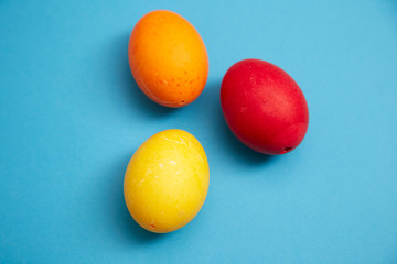 Three easter eggs on blue background