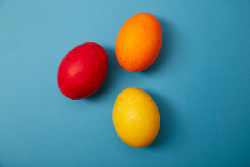 Three easter eggs on blue background