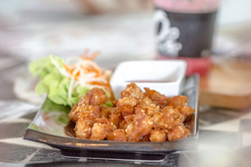 Blurred background of food (fried pork, fried chicken, french fries) served to customers and decorated with beautiful dishes for more appetizing