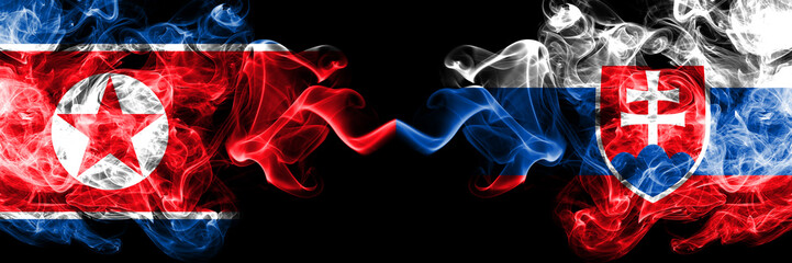 North Korea vs Slovakia, Slovakian smoky mystic flags placed side by side. Thick colored silky smoke flags of North Korea and Slovakia, Slovakian.