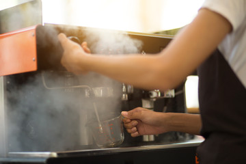 Employees working with coffee makers.