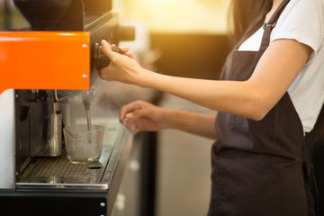 Employees working with coffee makers.