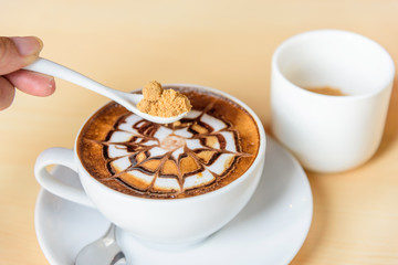 Add sugar to hot coffee / add sugar to hot cappuccino