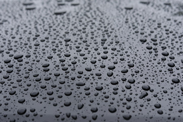 water rain drop on black modern vehicle car with glass coating glossy