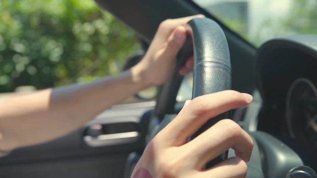 close-up shot of hands of man holding steering wheel of a car