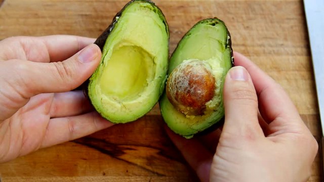 Cutting open an avocado.