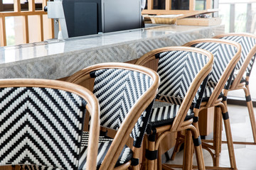 bar stools assemble in a beautiful diagonal row against the ba
