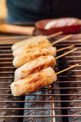 Grilled Cheese Stick on gas griller stove, street food at Ximending in Taiwan, Taipei.