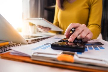 Business  women using calculator with computer laptop, Business accounting, budget and loan paper...