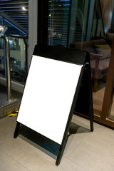 Mock up of blackboard standee sign in front of coffee shop.