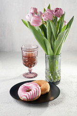 Sugar and Striped-glazed donuts with tea and tulips