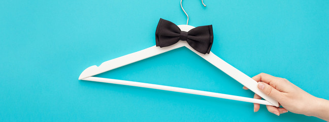 White wooden hangers on blue background