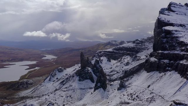 Spectacular Aerial Drone Flight over the snow covered The Old Man of Storr on the Isle of Skye, Scottish Highlands