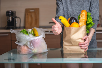 Woman chooses a paper bag with food and refuses to use plastic. Environmental protection and the...