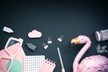 Pink colored objects on black background, top view