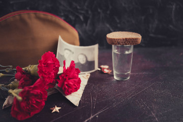 background for postcards by may 9, victory day: cap, letters, carnations and St. George ribbon Soviet icons and old photos