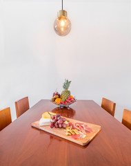Table with fruit and food in a wooden table. Healthy lifestyle concept.Spacious modern interior