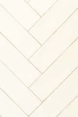 White tile herringbone pattern with gray grout for master bathroom